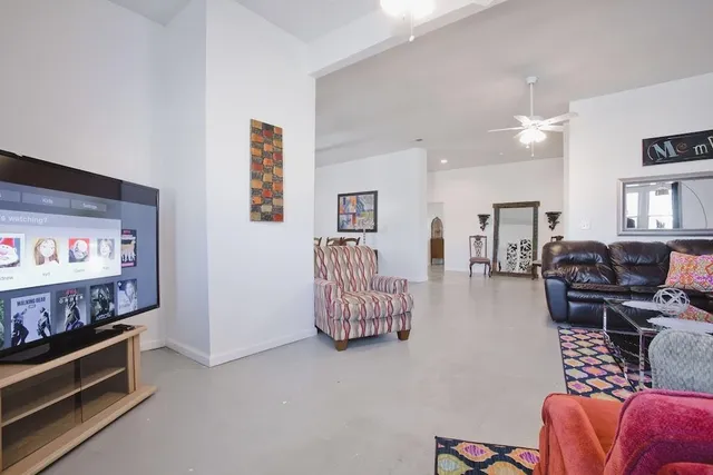 a living room with furniture gym equipment and a baby crib