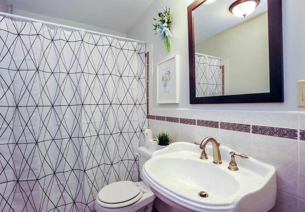 86 Edgemere Road Boston, MA 02132 - Photo 12 of 23 a bathroom with a sink a toilet and mirror