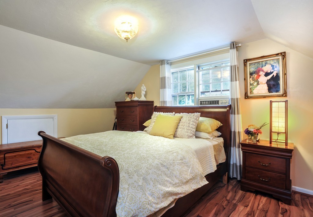 86 Edgemere Road Boston, MA 02132 - Photo 14 of 23 a bedroom with a bed and wooden floor