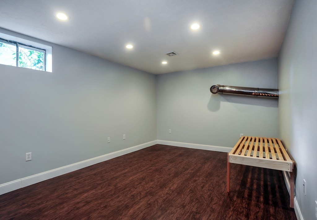 86 Edgemere Road Boston, MA 02132 - Photo 18 of 23 wooden floor in an empty room with a window