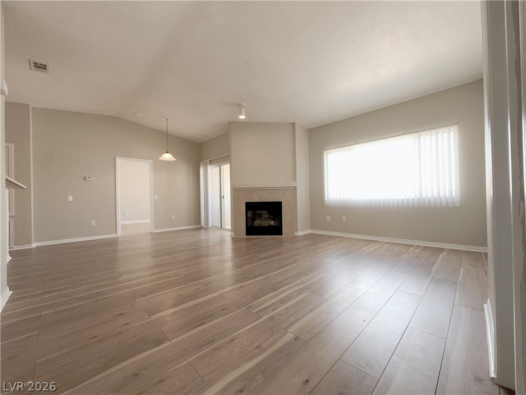 8725 West Flamingo Road, Unit 208 Las Vegas, NV 89147 - Photo 3 of 16 This living room features elegant wood flooring, a warm fireplace, and bright natural light.