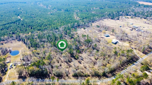 a backyard of a house with a yard and outdoor seating