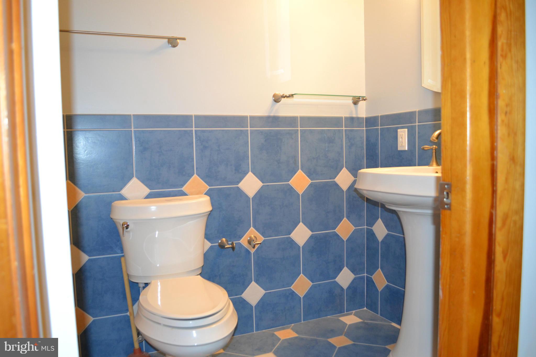 442 Andover Road Linthicum Heights, MD 21090 - Photo 6 of 8 a white toilet sitting next to a bathroom sink and a mirror