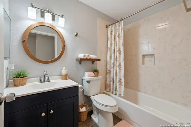 a bathroom with a sink a toilet and a mirror