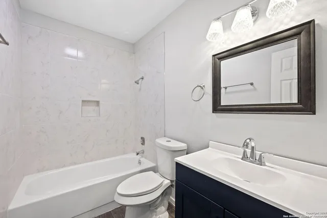 a bathroom with a toilet a sink and bathtub