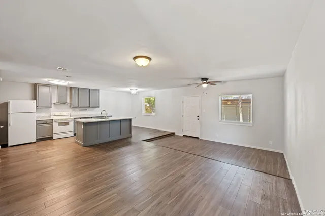 a view of kitchen with sink and wooden floor