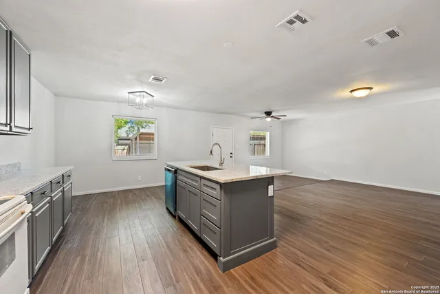 a kitchen with wooden floors and sink