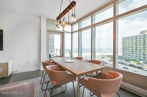 a dining room with furniture wooden floor and a potted plant