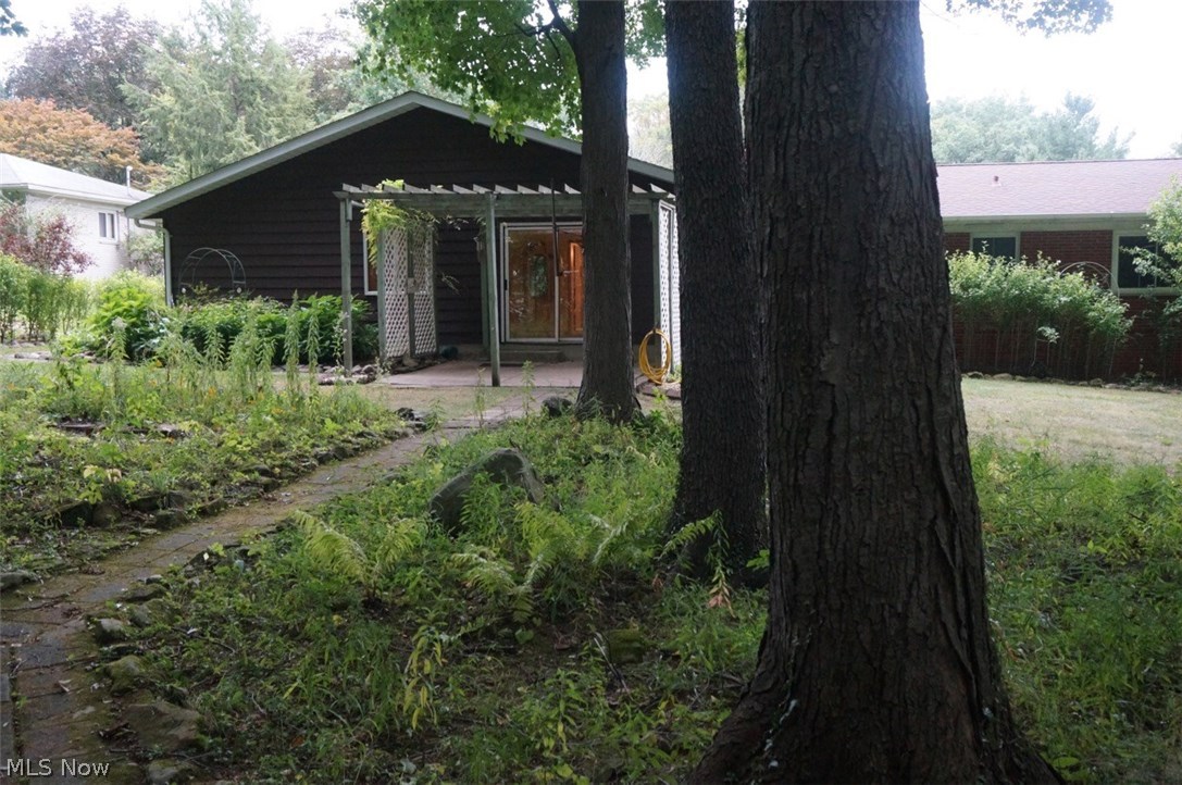 1087 Broadmoor Road Macedonia, OH 44056 - Photo 32 of 35 A view to the back of house and private patio off the family room. With a little TLC transform this backyard into your oasis! The walkway leads to...