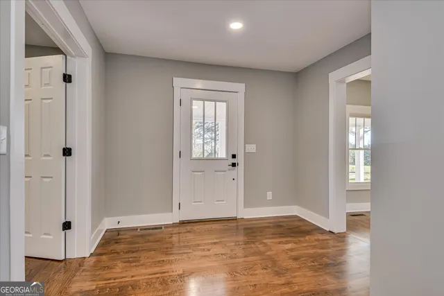 a view of an entryway with wooden floor and a window