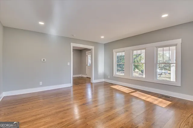a view of a hallway with wooden floor