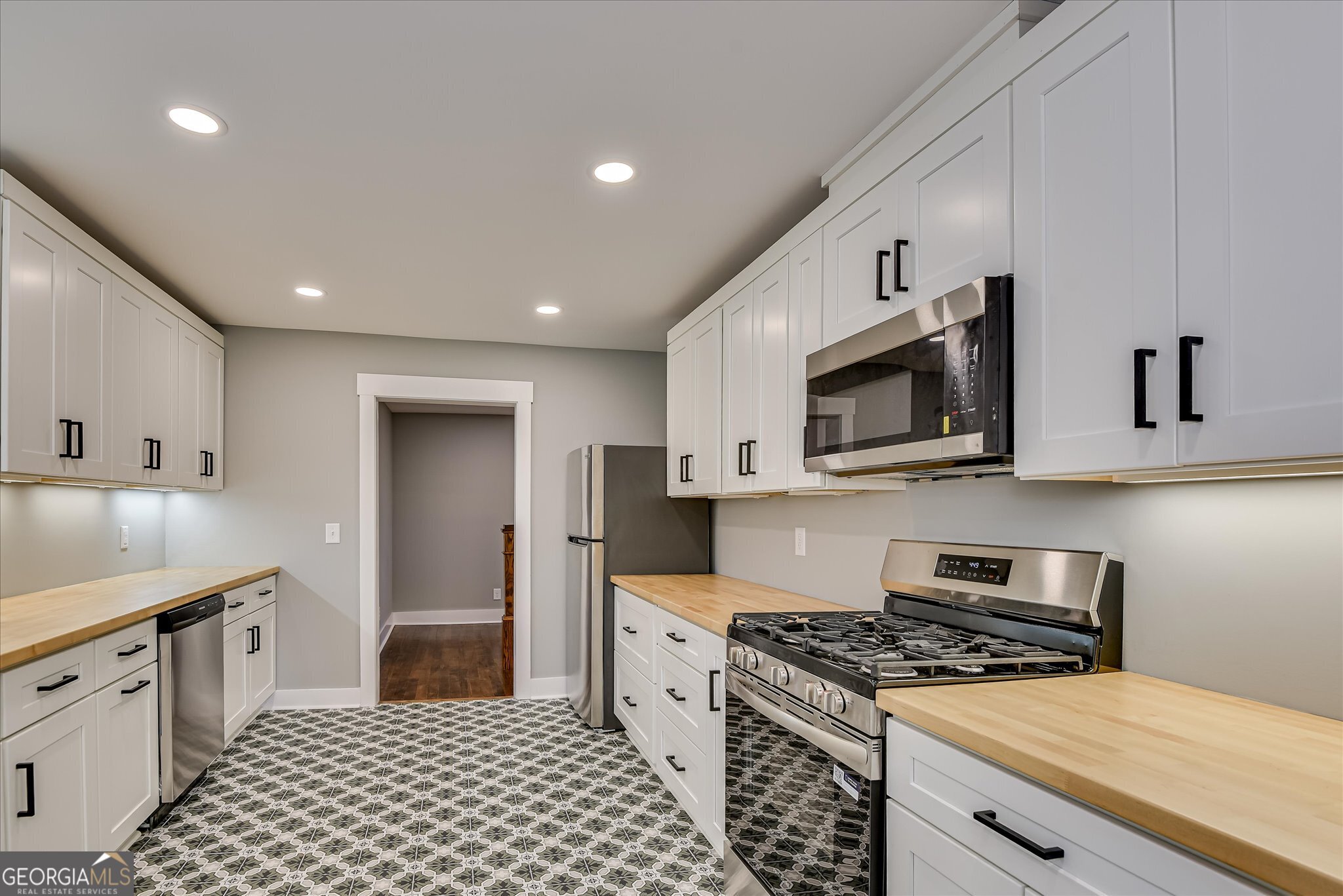 267 Garrard Road Washington, GA 30673 - Photo 27 of 74 a kitchen with stainless steel appliances granite countertop a stove a sink and a microwave