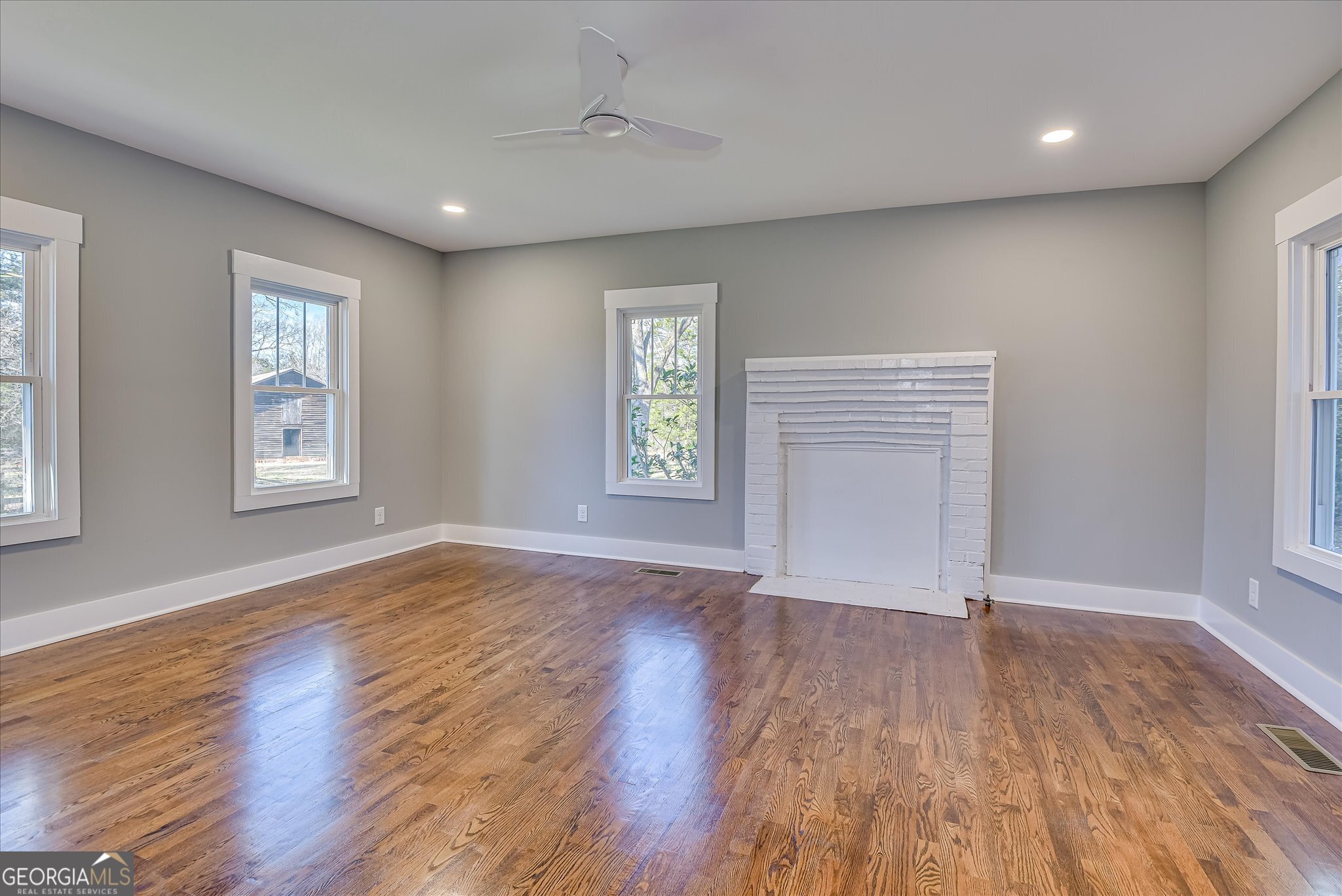 267 Garrard Road Washington, GA 30673 - Photo 38 of 74 an empty room with wooden floor and windows