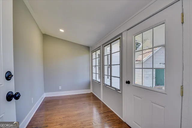 a view of a house with a yard outdoor seating and covered with trees