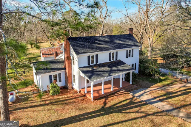a view of a swimming pool with an outdoor space and trees all around