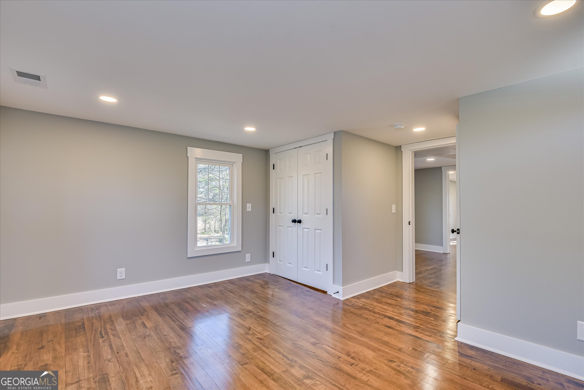 267 Garrard Road Washington, GA 30673 - Photo 49 of 74 a view of an empty room with window and wooden floor