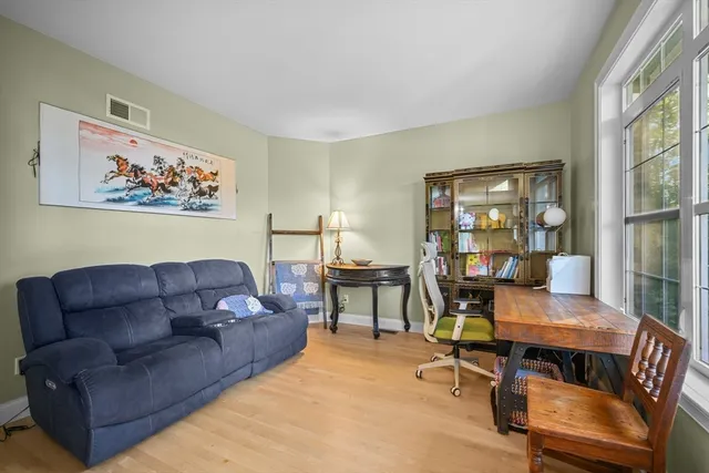 a living room with furniture a table and a large window