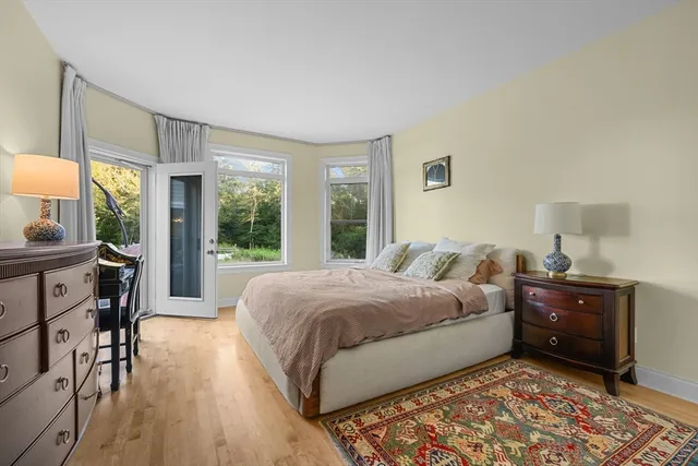 a living room with a bed furniture and a window