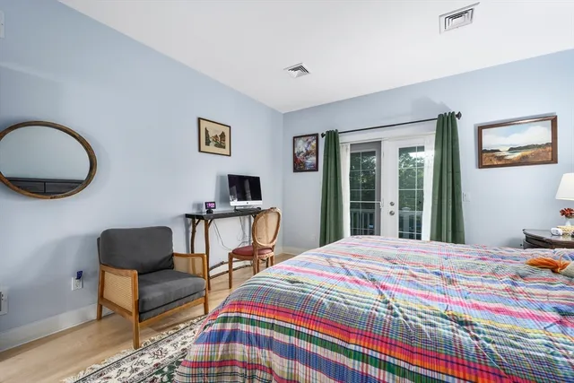 a bedroom with a bed and a chair