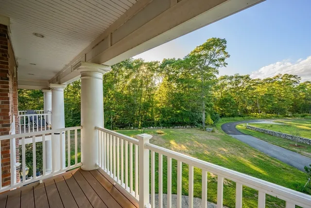 a view of a wooden deck next to a yard