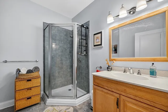 a bathroom with a shower sink and mirror