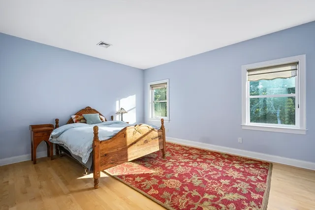 a bed sitting in a bedroom next to a window