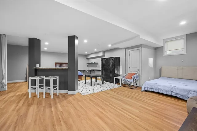 a living room with furniture a flat screen tv and kitchen view