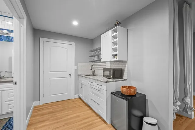 a kitchen with a stove a sink and cabinets