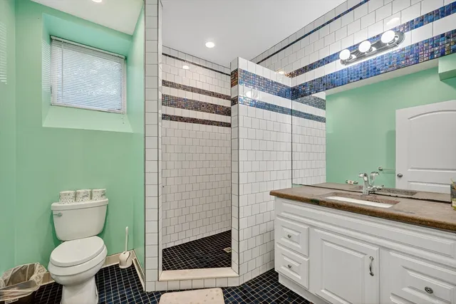 a bathroom with a toilet sink and mirror