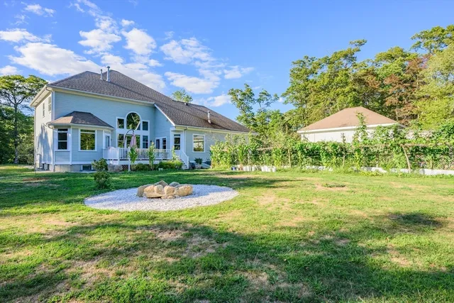 a front view of house with yard and outdoor seating
