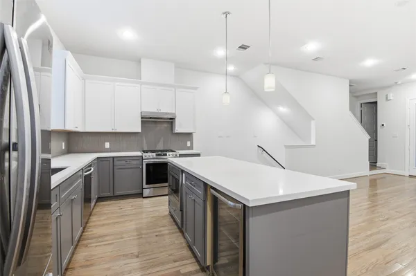 a kitchen with a stove sink and cabinets
