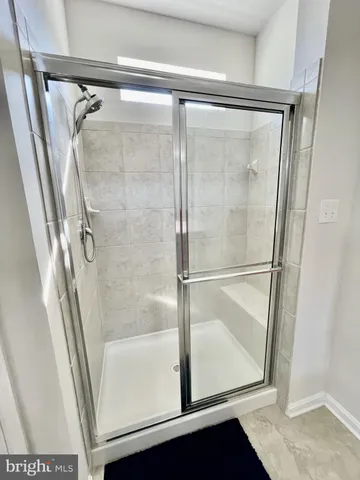 a bathroom with a glass shower door