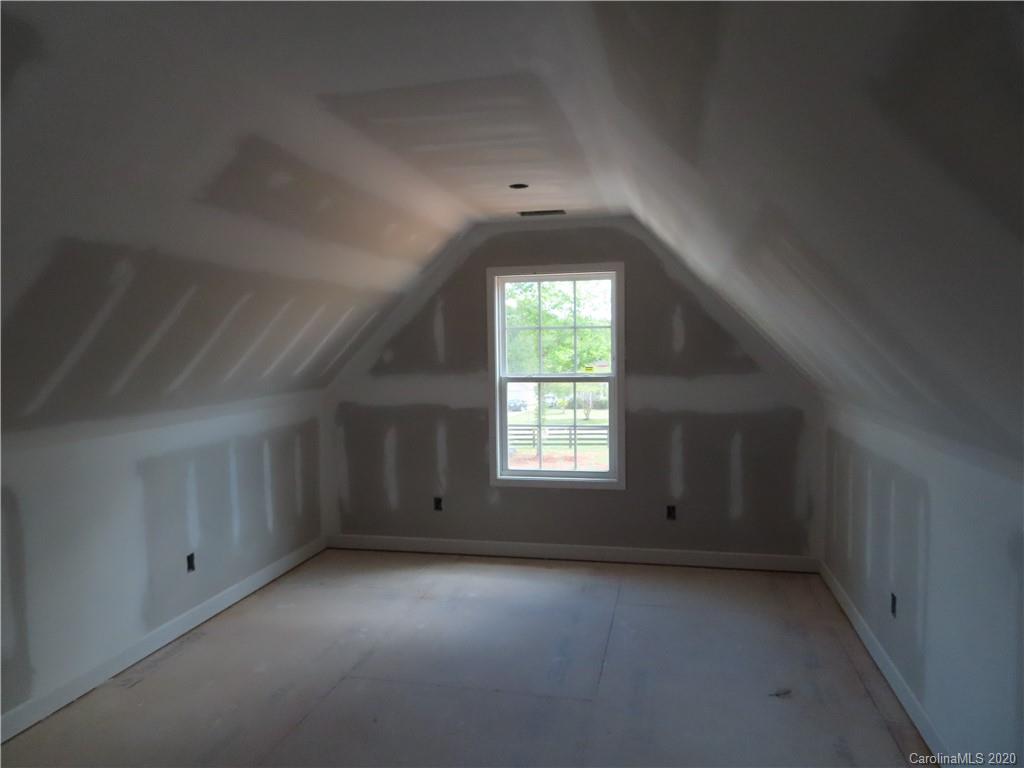 2219 Cedar Road York, SC 29745 - Photo 13 of 14 an empty room with a window and a fireplace