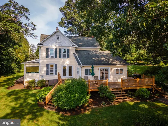 a kitchen with granite countertop a sink stainless steel appliances wooden floor and cabinets