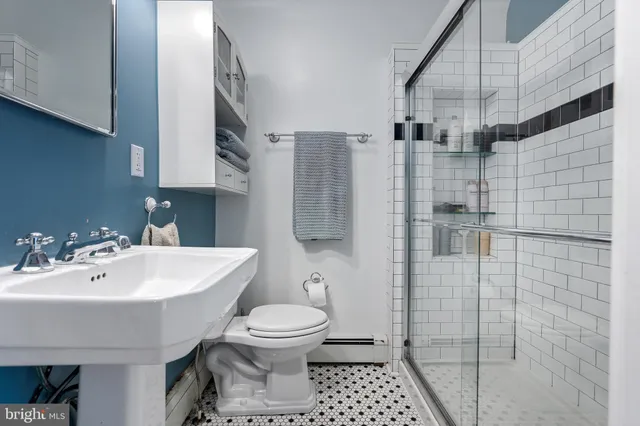 a view of a workspace with furniture and a book shelf