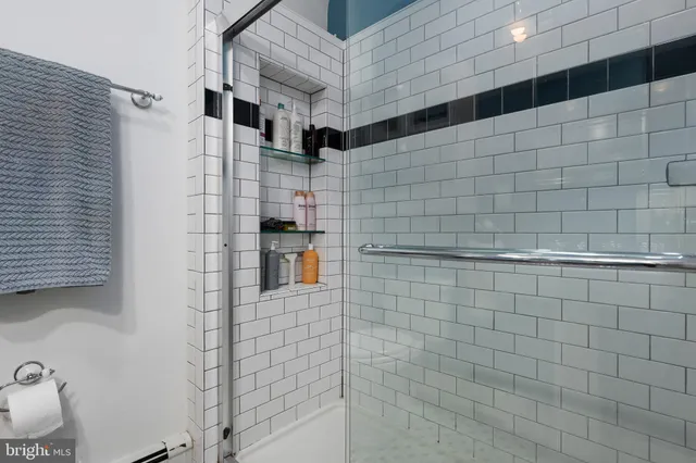 a bedroom with a bed chairs and wooden floor