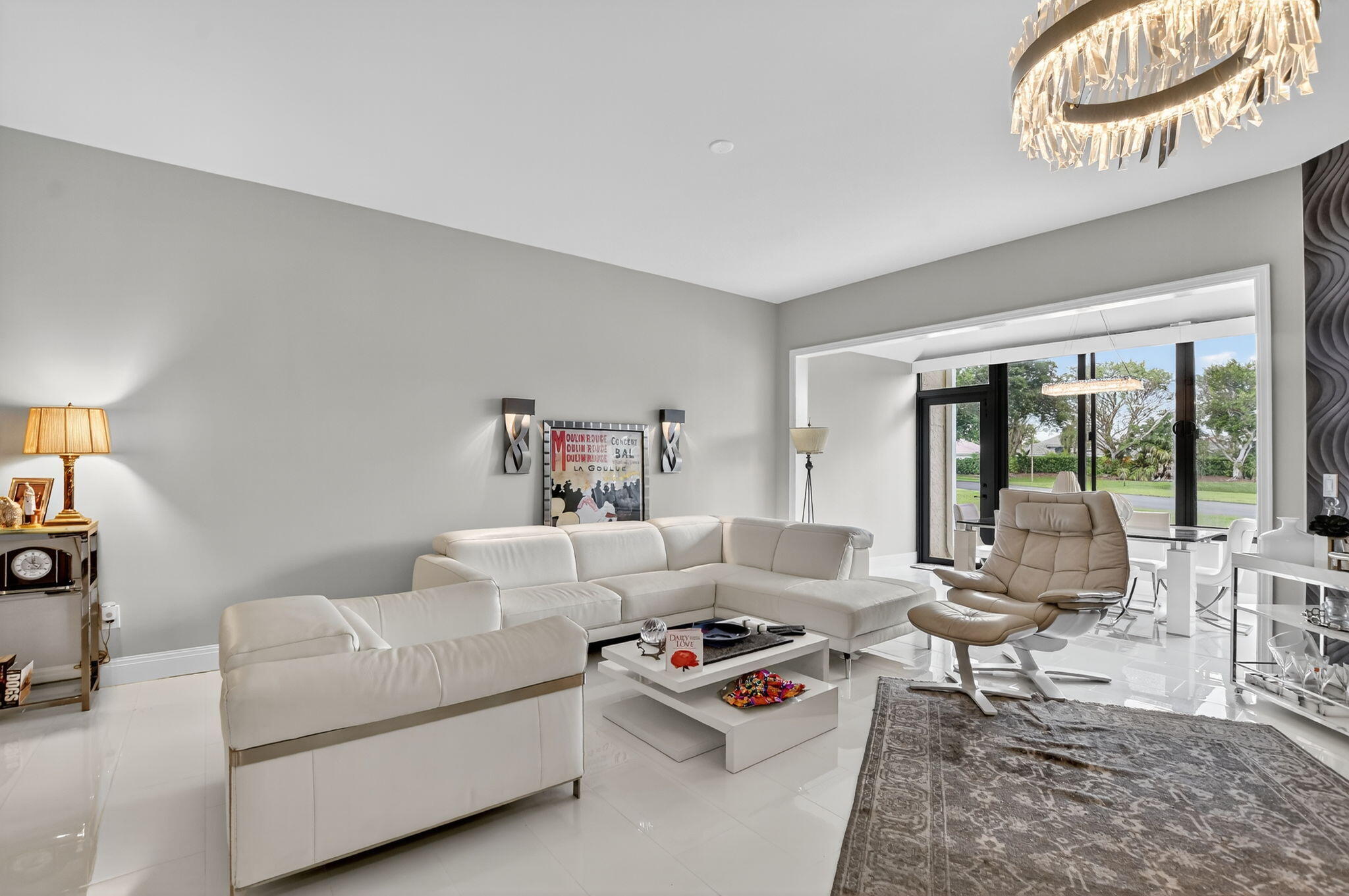 7535 La Paz Boulevard, Unit 105 Boca Raton, FL 33433 - Photo 2 of 54 a living room with furniture and a large window