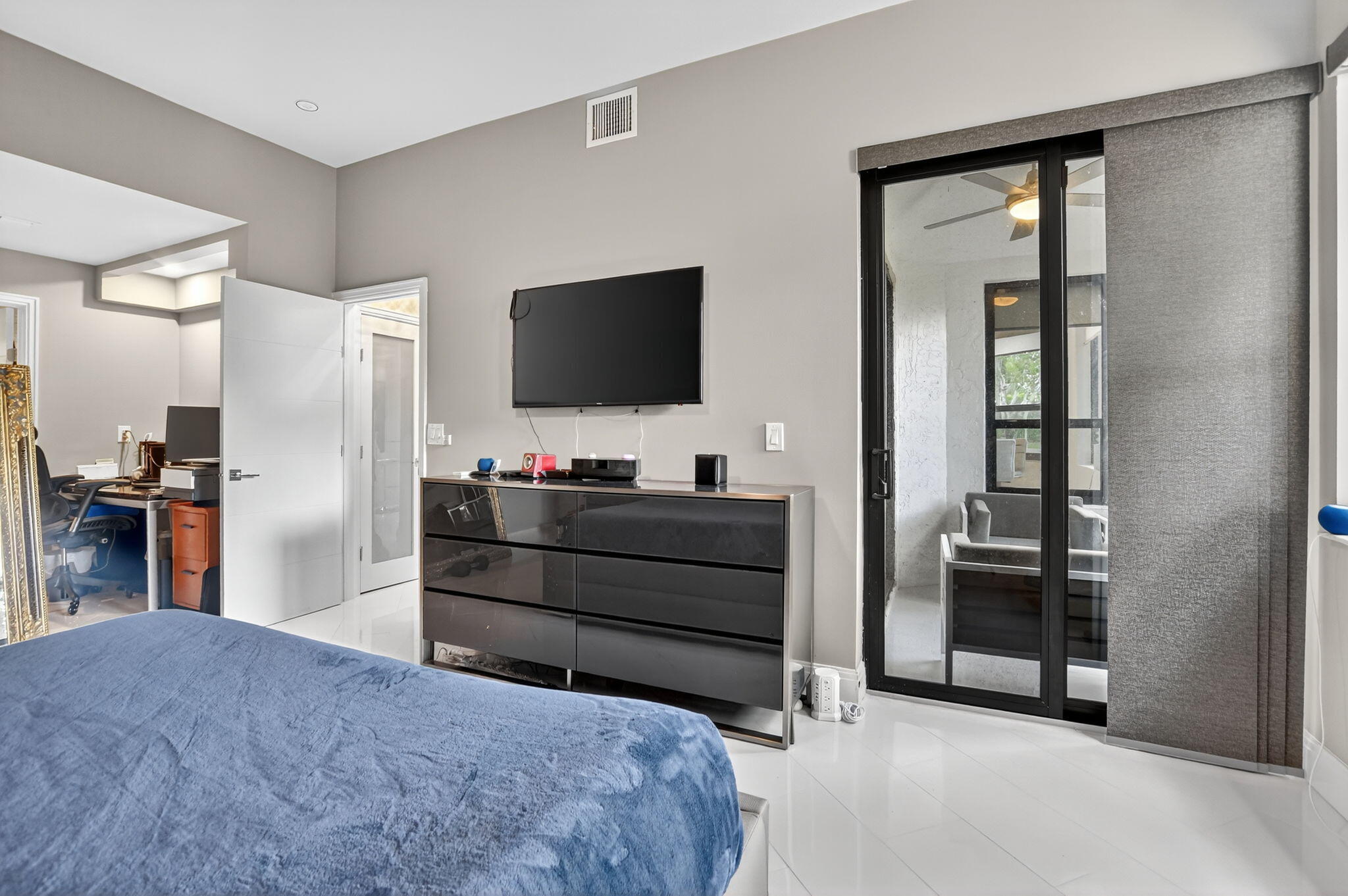 7535 La Paz Boulevard, Unit 105 Boca Raton, FL 33433 - Photo 24 of 54 a bedroom with a bed and a flat screen tv