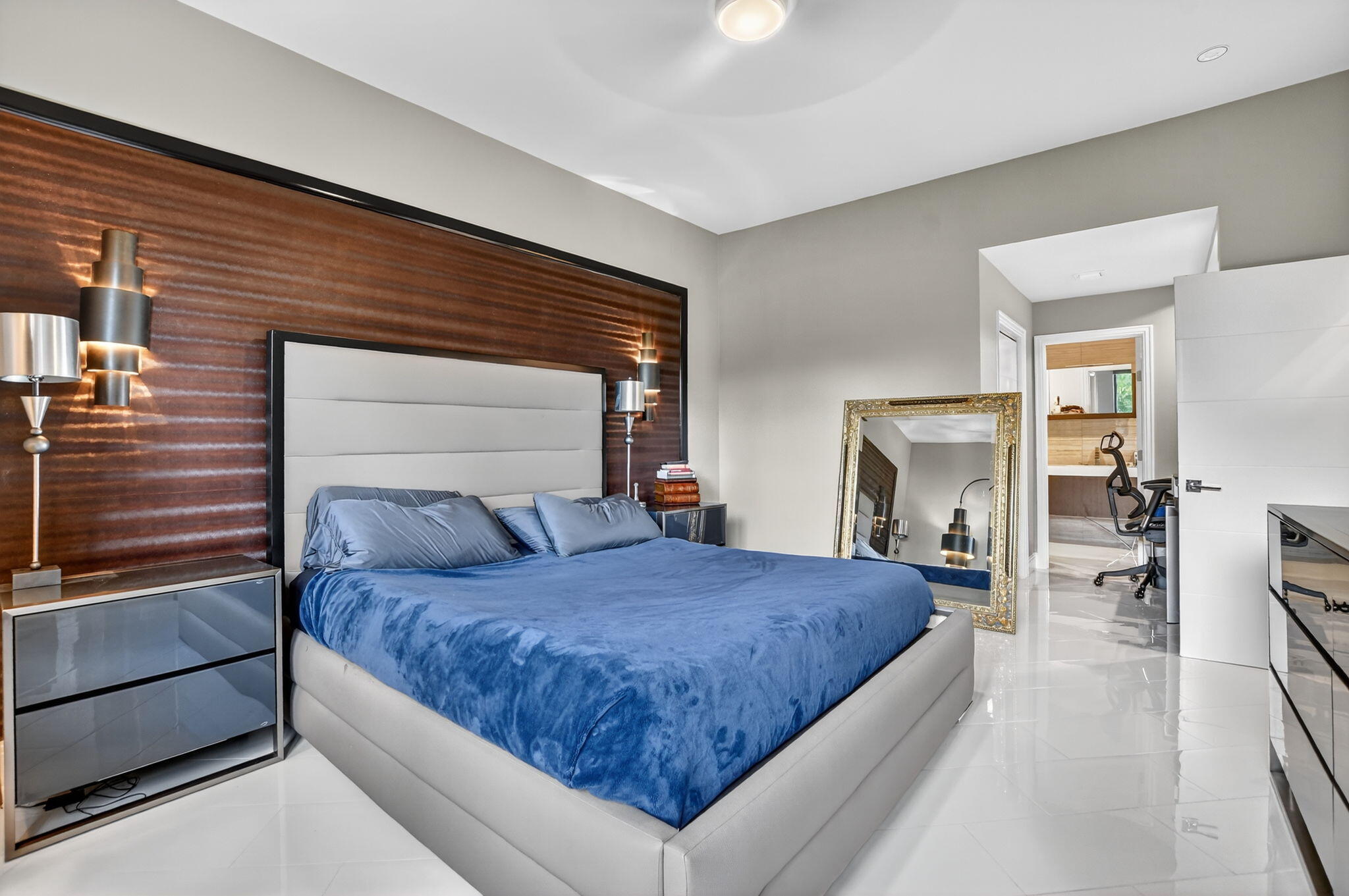 7535 La Paz Boulevard, Unit 105 Boca Raton, FL 33433 - Photo 25 of 54 a bedroom with a large bed and a chandelier