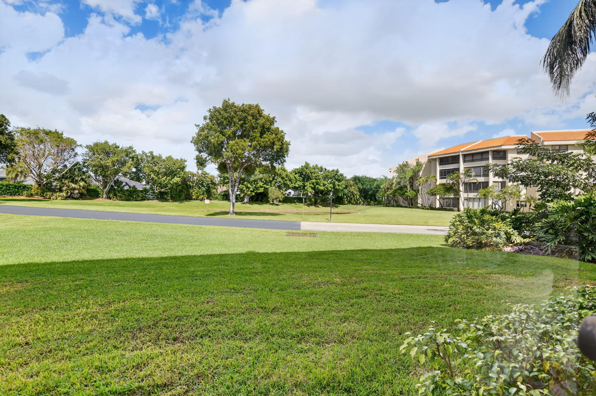 7535 La Paz Boulevard, Unit 105 Boca Raton, FL 33433 - Photo 5 of 54 a view of a fountain in front of a house with a big yard