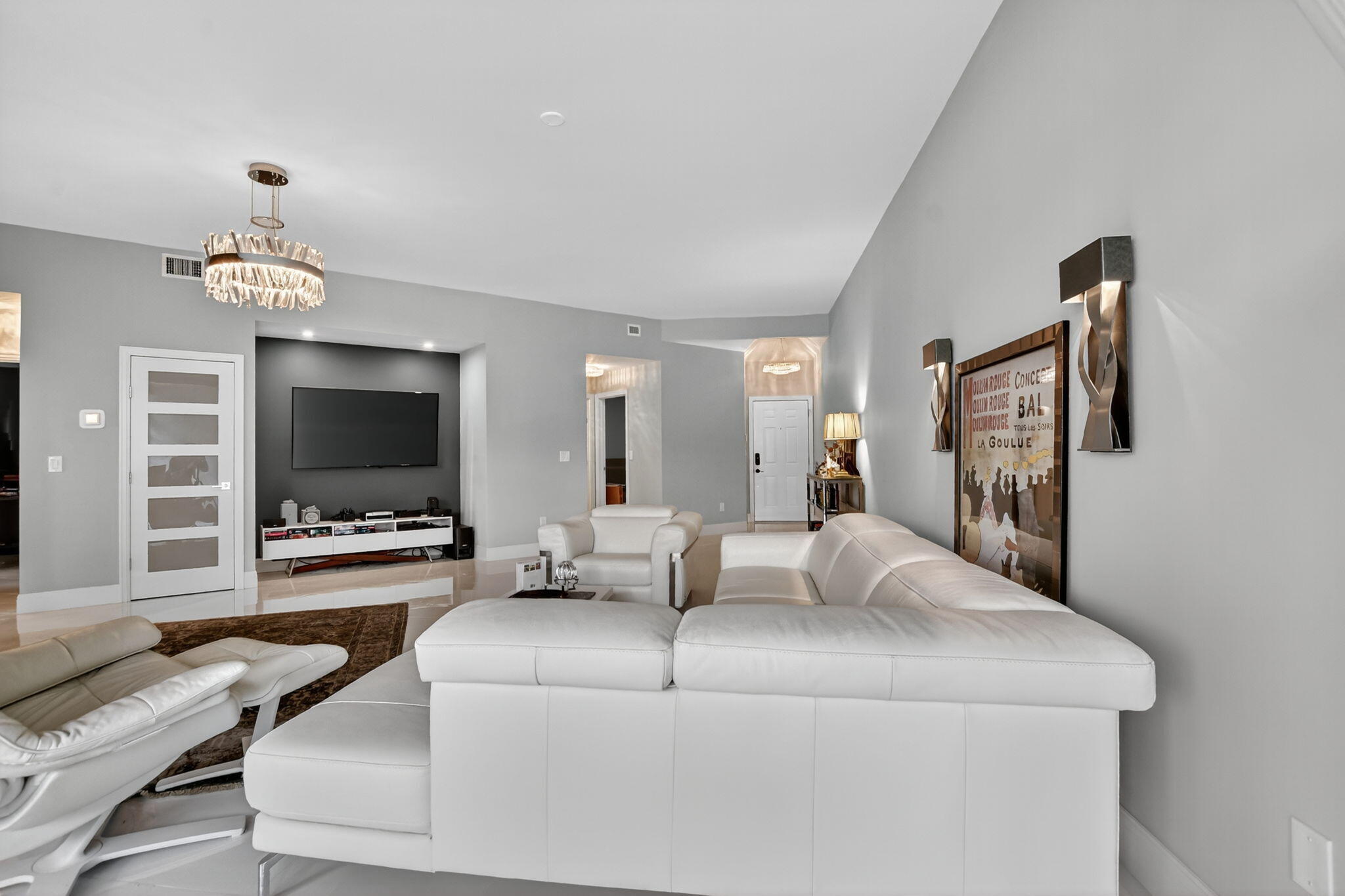 7535 La Paz Boulevard, Unit 105 Boca Raton, FL 33433 - Photo 10 of 54 a living room with furniture and a flat screen tv