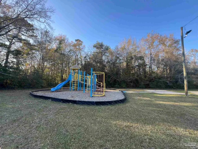 a view of a playground with a tiny play house