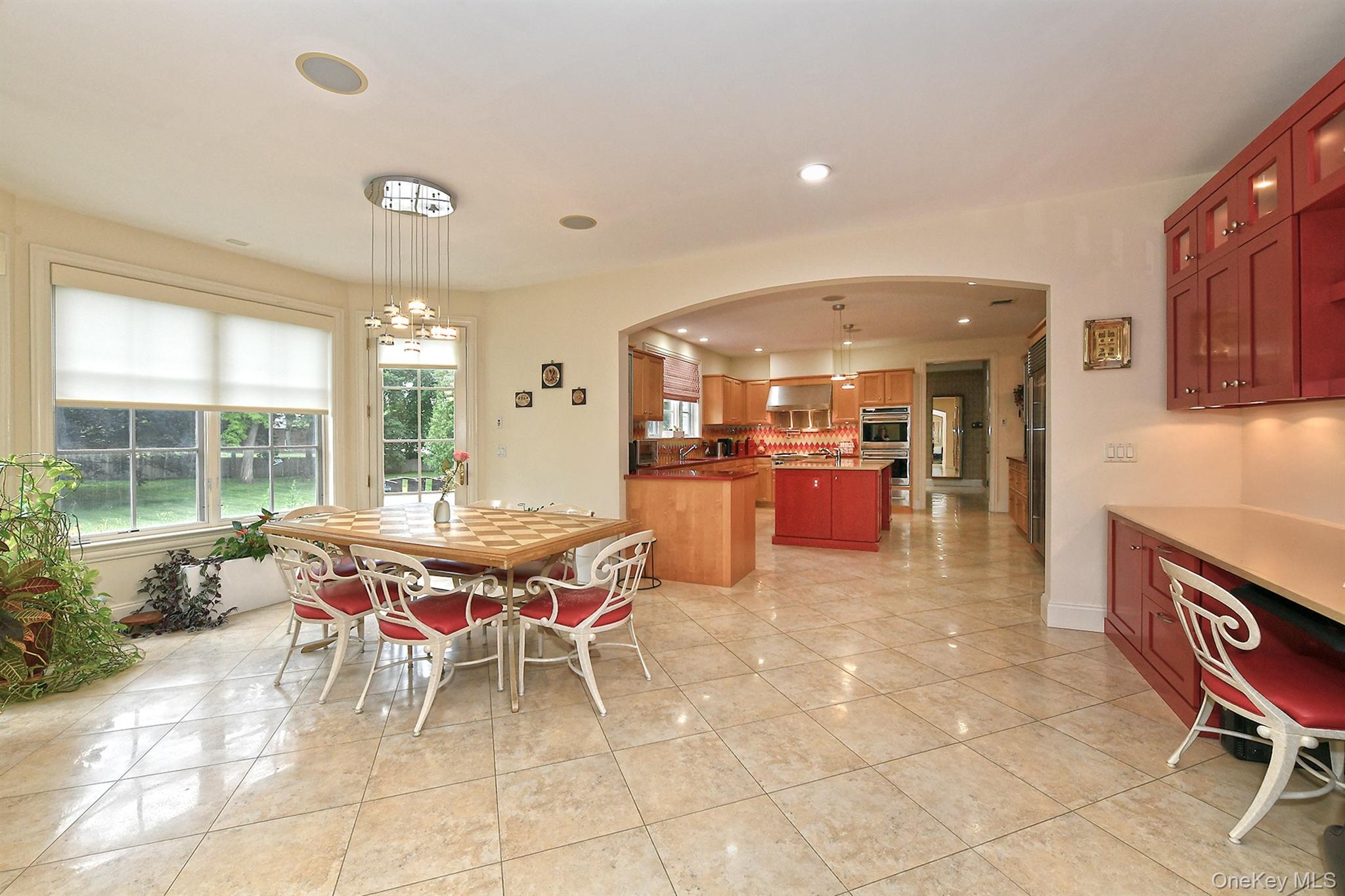 14 Norgate Road Glen Head, NY 11545 - Photo 17 of 44 a dining hall with stainless steel appliances kitchen island granite countertop a table and chairs in it