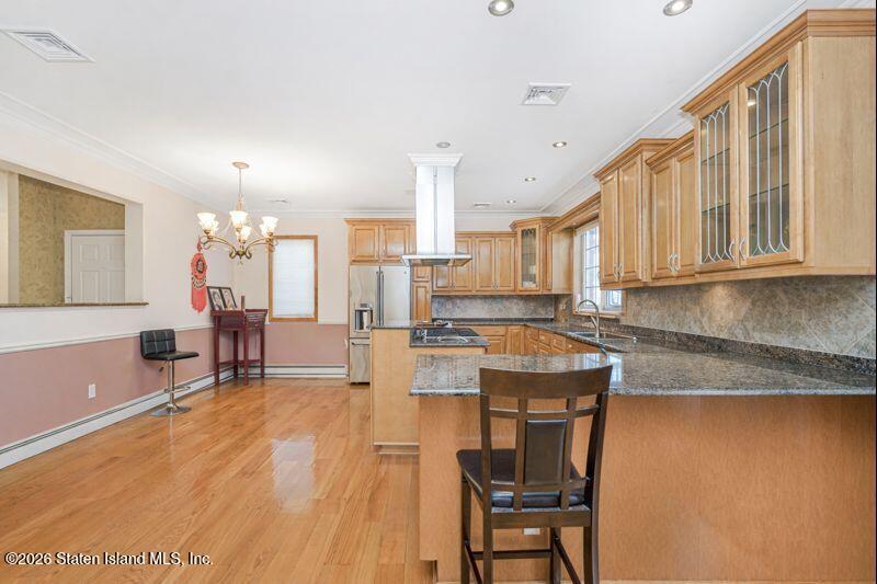 5125 Amboy Road Staten Island, NY 10312 - Photo 16 of 33 a room with stainless steel appliances kitchen island granite countertop furniture and a kitchen view