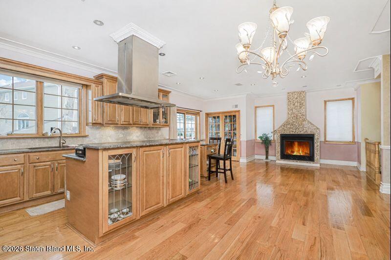 5125 Amboy Road Staten Island, NY 10312 - Photo 18 of 33 a kitchen with stainless steel appliances granite countertop a stove top oven a refrigerator with a dining table and chairs with wooden floor