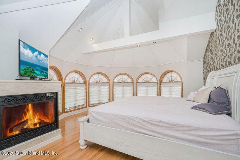 5125 Amboy Road Staten Island, NY 10312 - Photo 25 of 33 a large white bed with fireplace a mirror next to a window