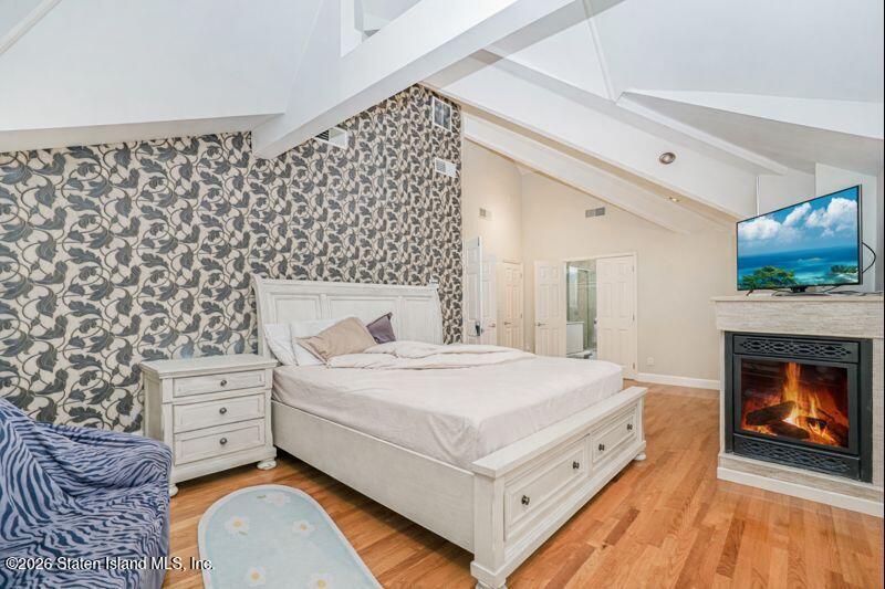 5125 Amboy Road Staten Island, NY 10312 - Photo 27 of 33 a bedroom with a bed and a fireplace