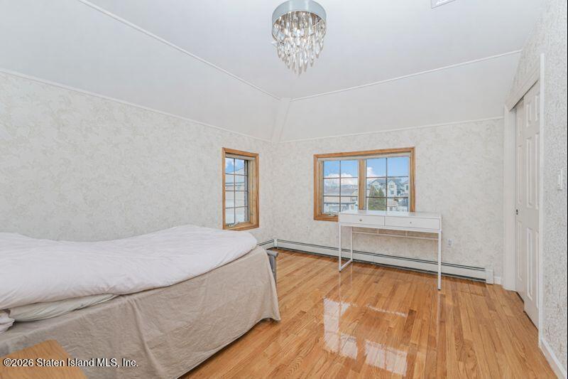 5125 Amboy Road Staten Island, NY 10312 - Photo 31 of 33 a spacious bedroom with a bed and a window
