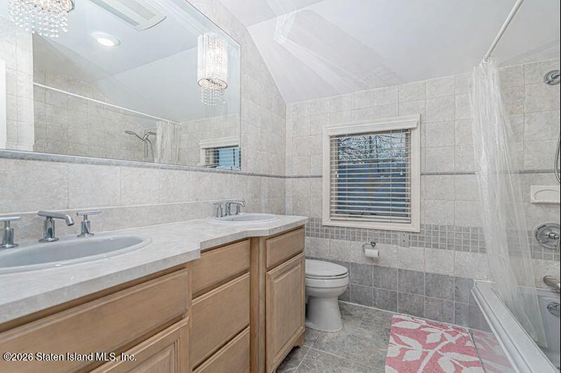 5125 Amboy Road Staten Island, NY 10312 - Photo 33 of 33 a bathroom with a granite countertop sink a toilet a mirror and shower