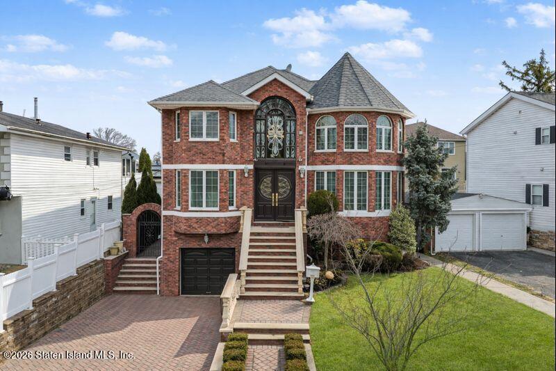 5125 Amboy Road Staten Island, NY 10312 - Photo 4 of 33 a front view of a house with a garden